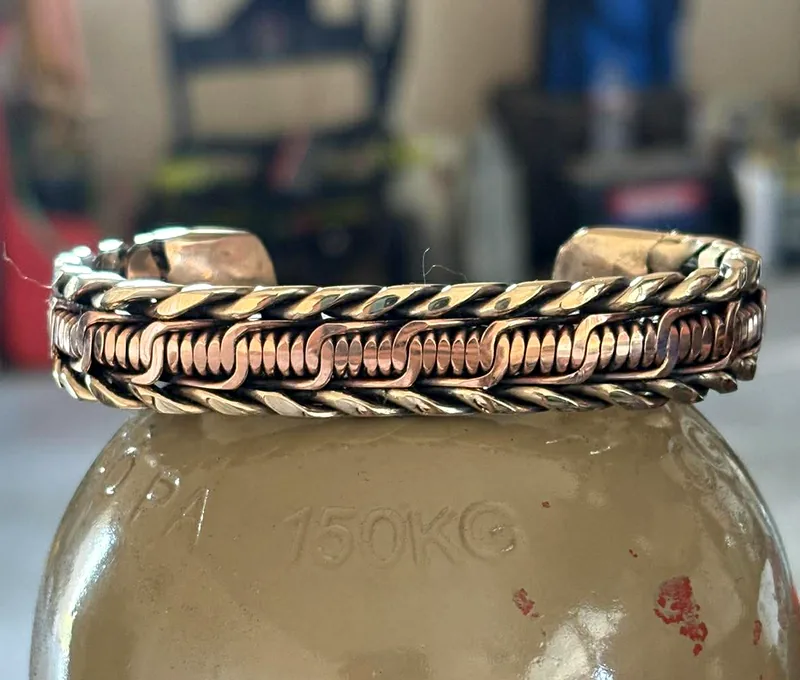 Hand-woven copper barbwire cuff bracelet with bronze twisted rope edges.